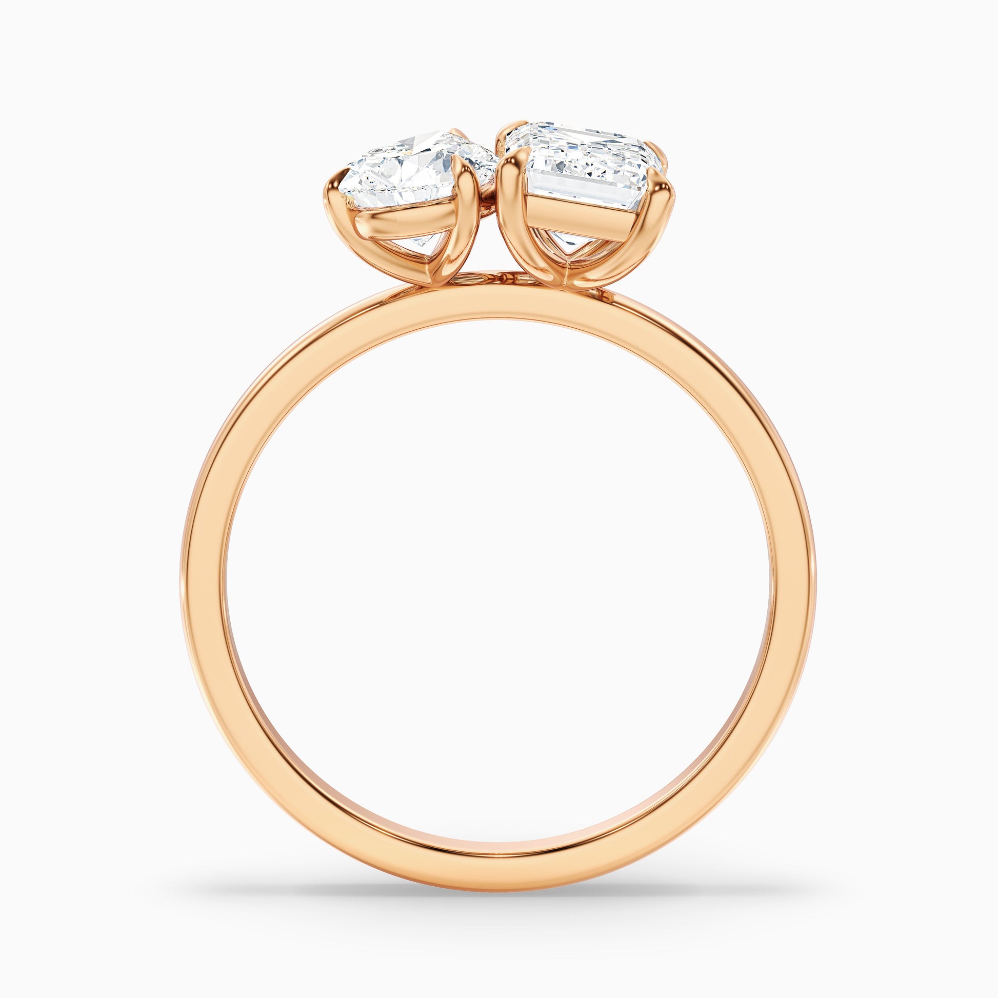 Side view of Cecelia Toi Et Moi diamond ring in rose gold with pear and emerald cut diamonds, showcasing moissanite and lab-grown diamond choices for engagement