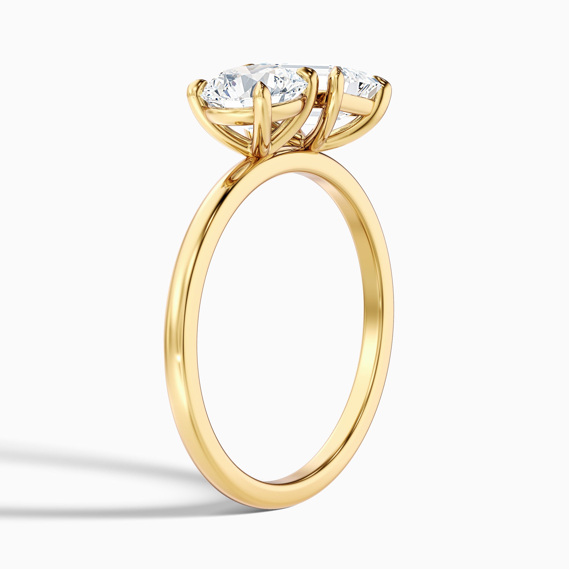 Joanna Toi Et Moi Diamond Ring in Yellow Gold, showcasing Round and Emerald Cut Diamonds, available in Moissanite and Lab-Grown Diamond. A classic and sophisticated engagement ring